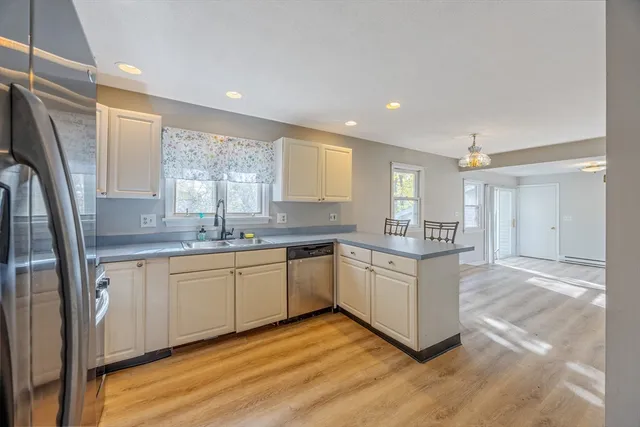 a kitchen with stainless steel appliances granite countertop a stove a sink and a refrigerator