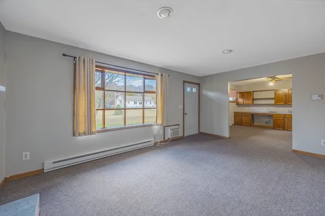 a furnished livingroom with a workspace