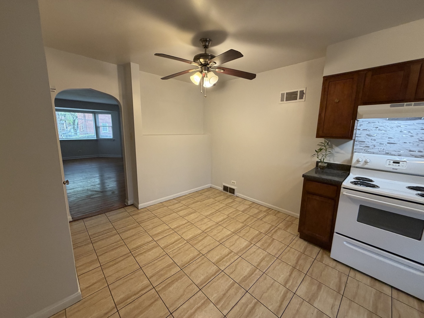 312 East 83rd Street, Unit 1 Chicago, IL 60619 - Photo 12 of 18 a bedroom with a bed and a chandelier