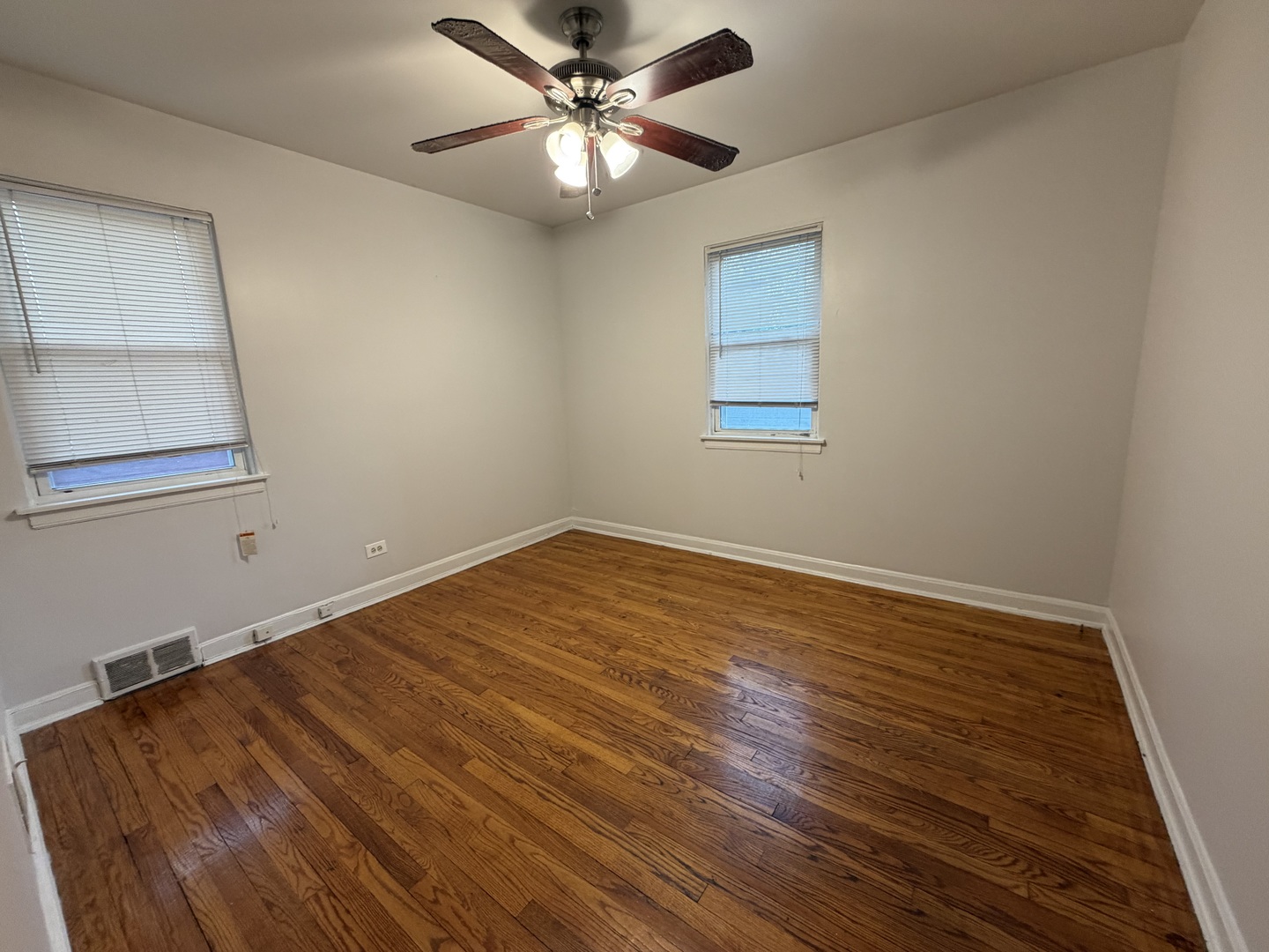 312 East 83rd Street, Unit 1 Chicago, IL 60619 - Photo 14 of 18 wooden floor in an empty room with a window