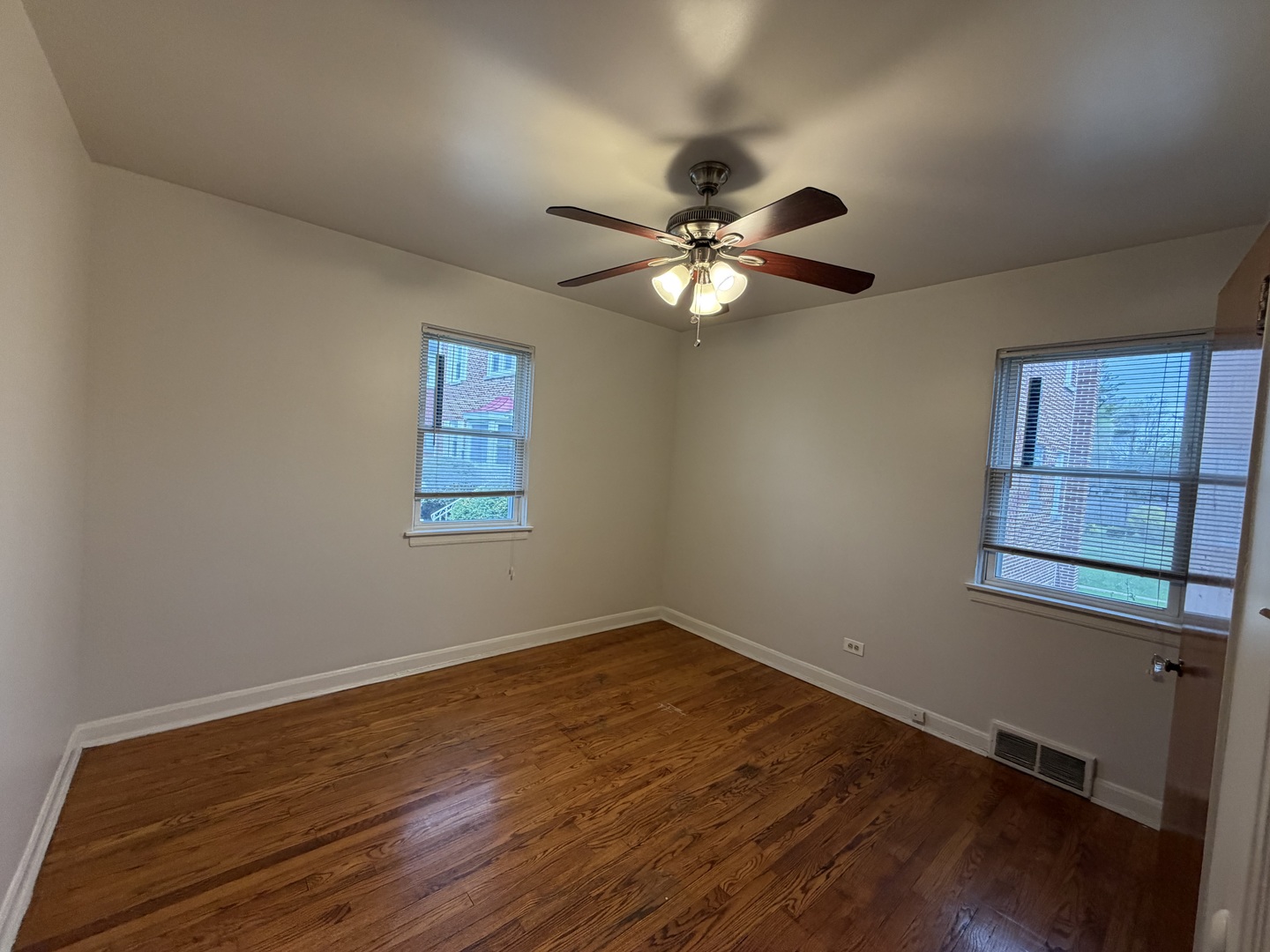 312 East 83rd Street, Unit 1 Chicago, IL 60619 - Photo 15 of 18 a view of a big room with wooden floor and windows