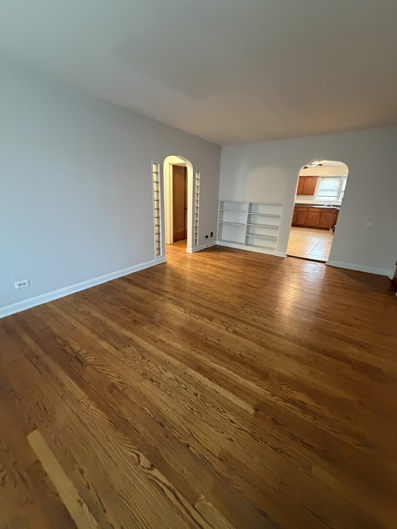 312 East 83rd Street, Unit 1 Chicago, IL 60619 - Photo 8 of 18 a view of empty room with wooden floor