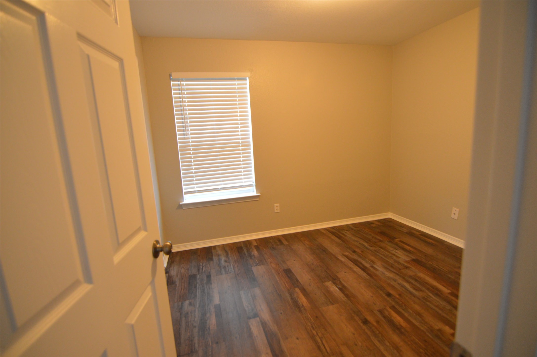 24131 Bar Kay Lane Hockley, TX 77447 - Photo 6 of 14 a view of an empty room with wooden floor and a window