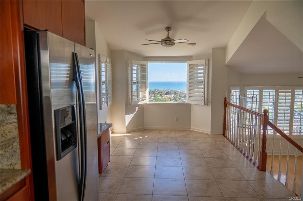 128 Avenida Trieste San Clemente, CA 92672 - Photo 3 of 14 a view of a kitchen with a refrigerator a sink wooden floor a fireplace and a way to kitchen