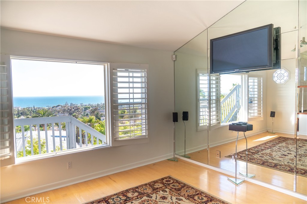 128 Avenida Trieste San Clemente, CA 92672 - Photo 6 of 14 a living room with hardwood floor and a large window