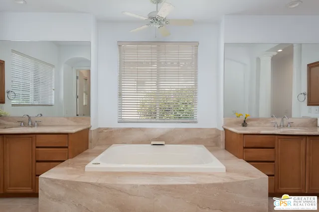 a spacious bathroom with a granite countertop tub sink and mirror
