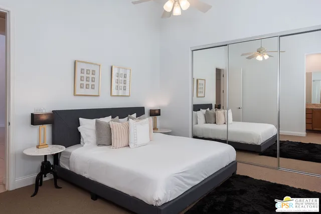 a bedroom with a bed and a lamp