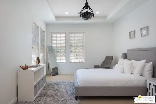 a bedroom with a bed and a chandelier