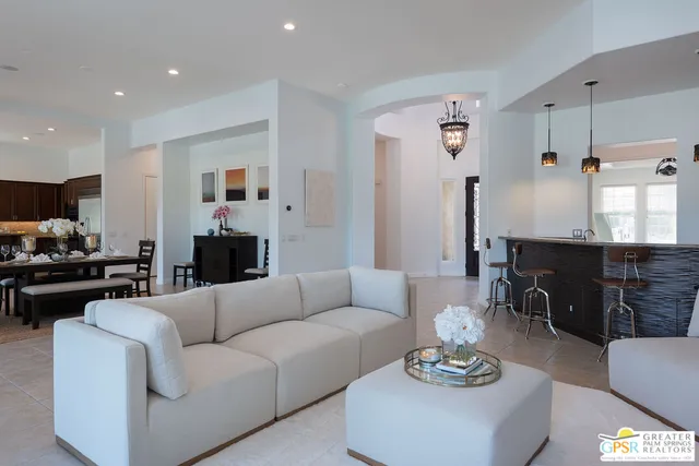 a living room with furniture kitchen view and a table