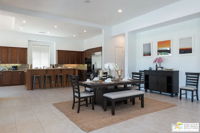 a living room with lots of furniture and kitchen view