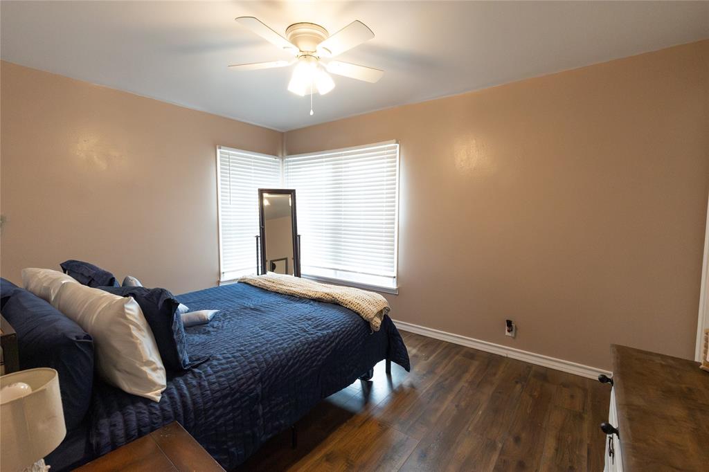 3205 42nd Street Snyder, TX 79549 - Photo 13 of 31 a bedroom with a bed and a chandelier