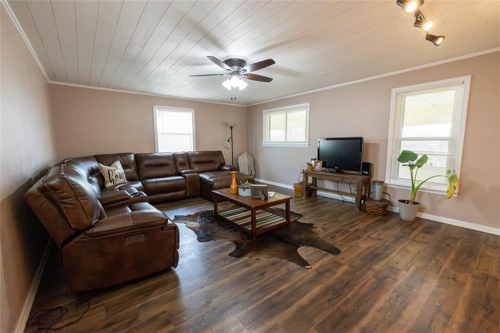 3205 42nd Street Snyder, TX 79549 - Photo 18 of 31 a living room with furniture and a flat screen tv