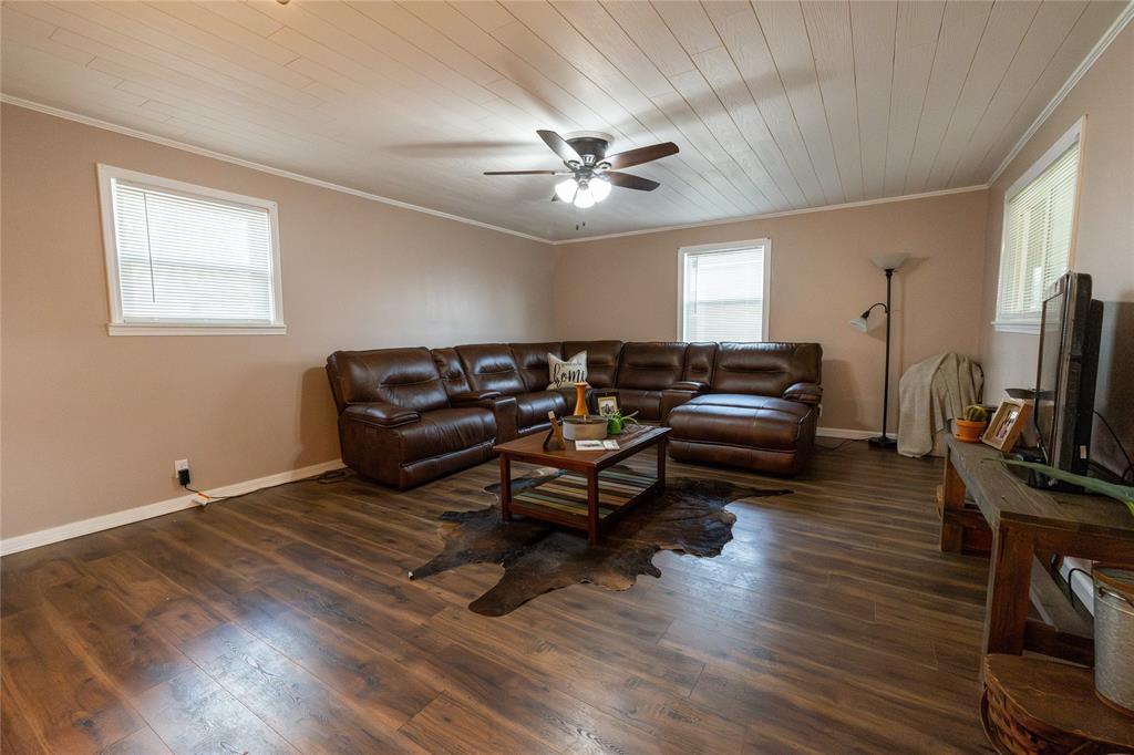 3205 42nd Street Snyder, TX 79549 - Photo 19 of 31 a living room with furniture a flat screen tv and a window