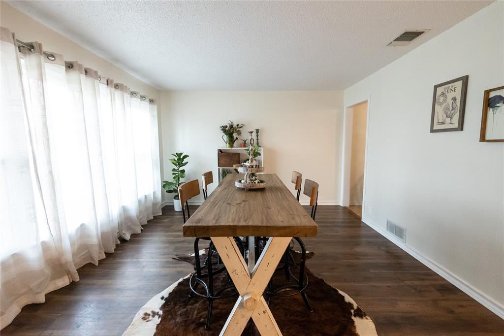 3205 42nd Street Snyder, TX 79549 - Photo 3 of 31 a dining room with wooden floor table and chairs
