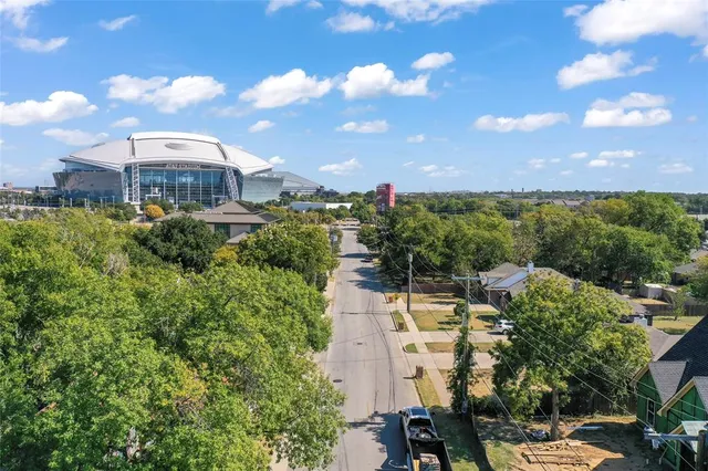 a large parking space with lots of trees in the back
