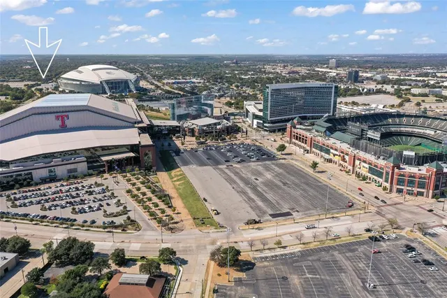 a view of a city with lawn chairs under an umbrella