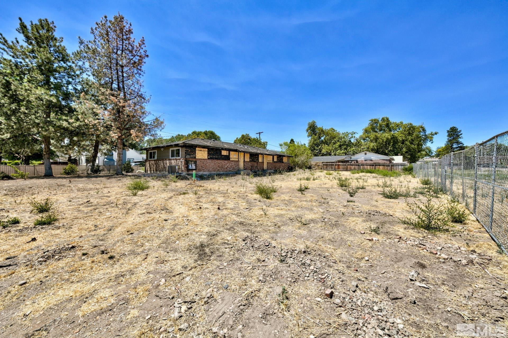 1587 Plumas Street Reno, NV 89509 - Photo 8 of 13 a view of a yard with a tree