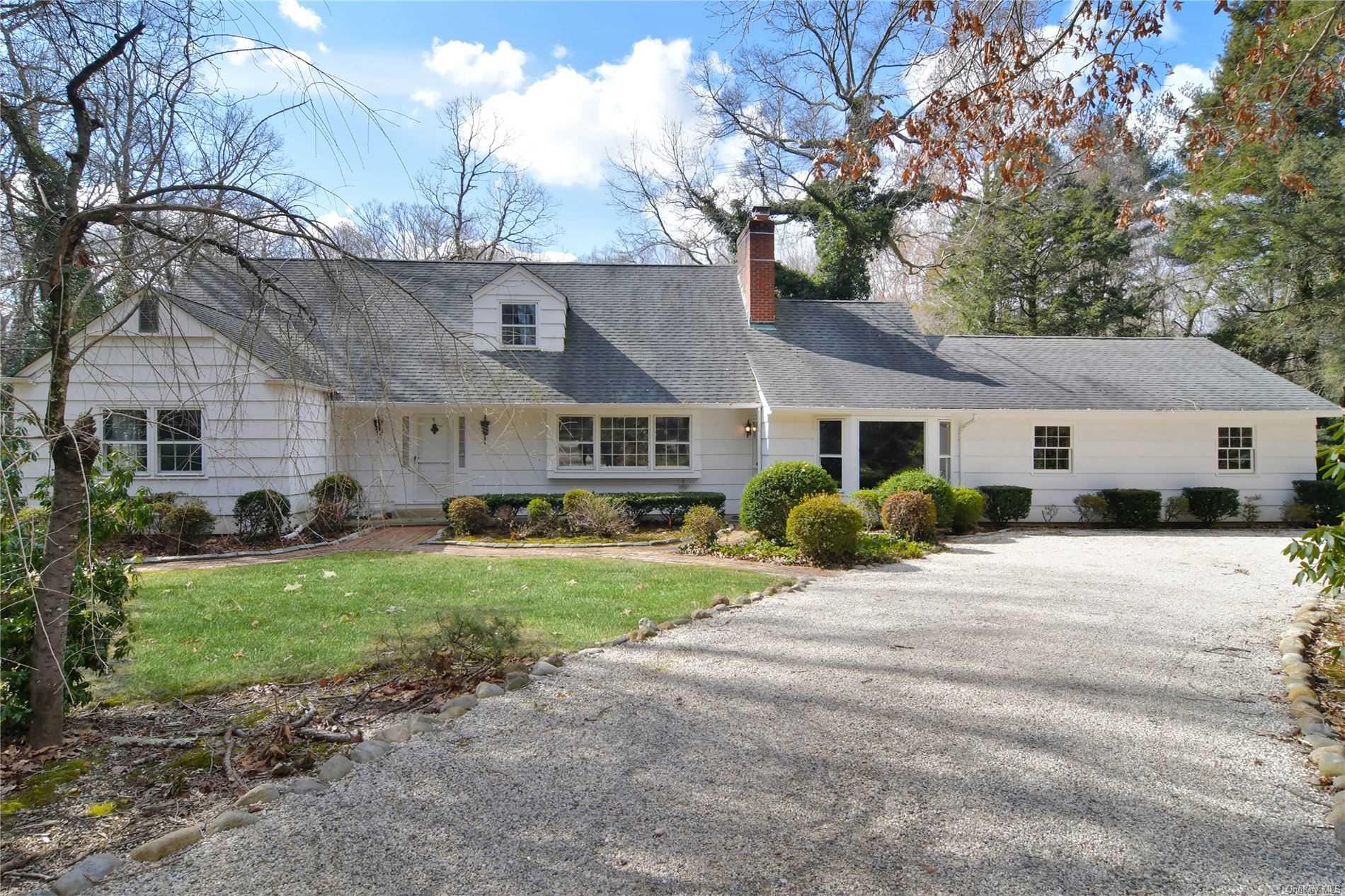 31 White Oak Tree Road Laurel Hollow, NY 11791 - Photo 1 of 1 a front view of a house with a yard