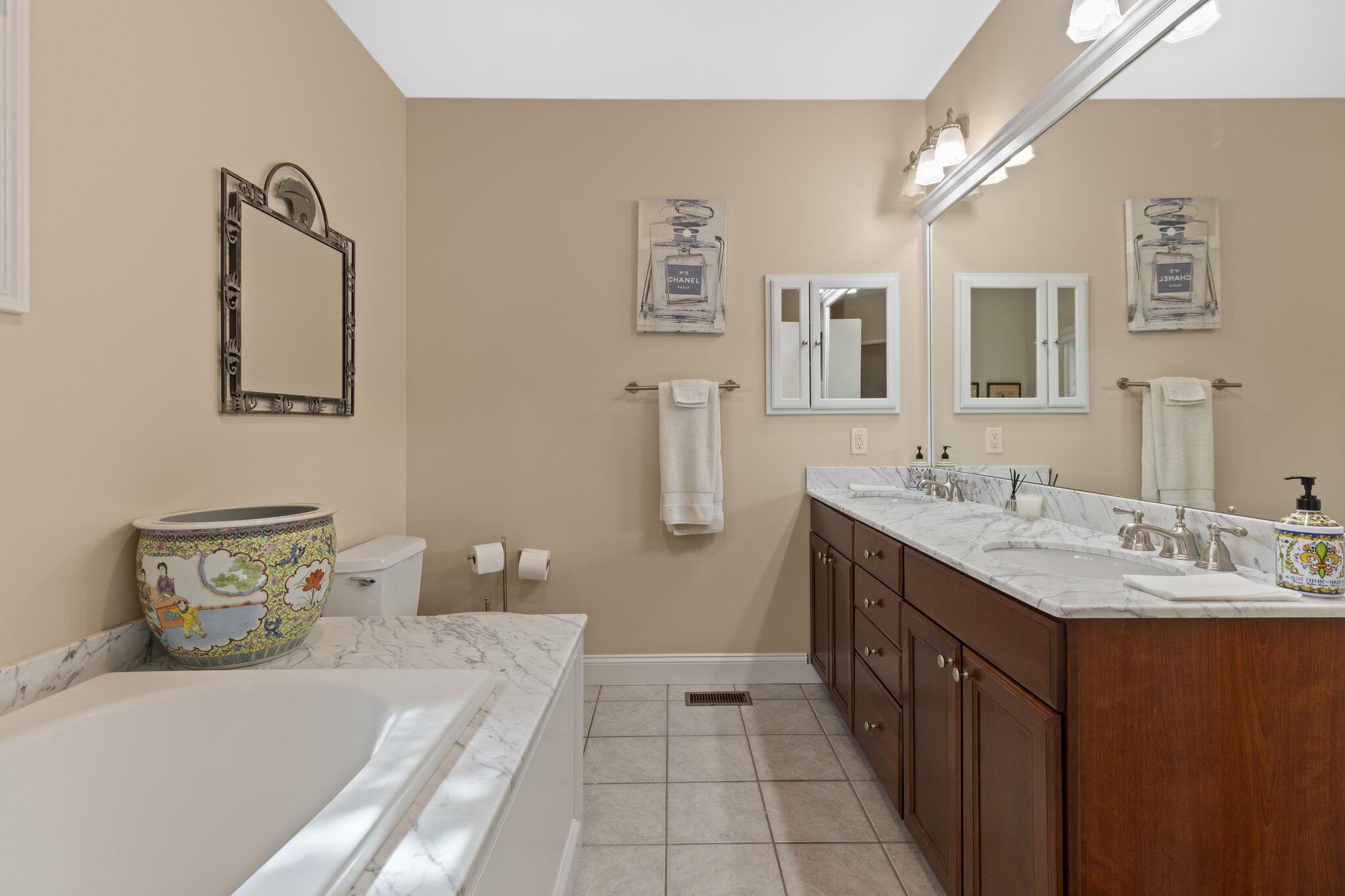 137 Cairn Ridge Road East Falmouth, MA 02536 - Photo 29 of 70 a spacious bathroom with a double vanity sink and a mirror