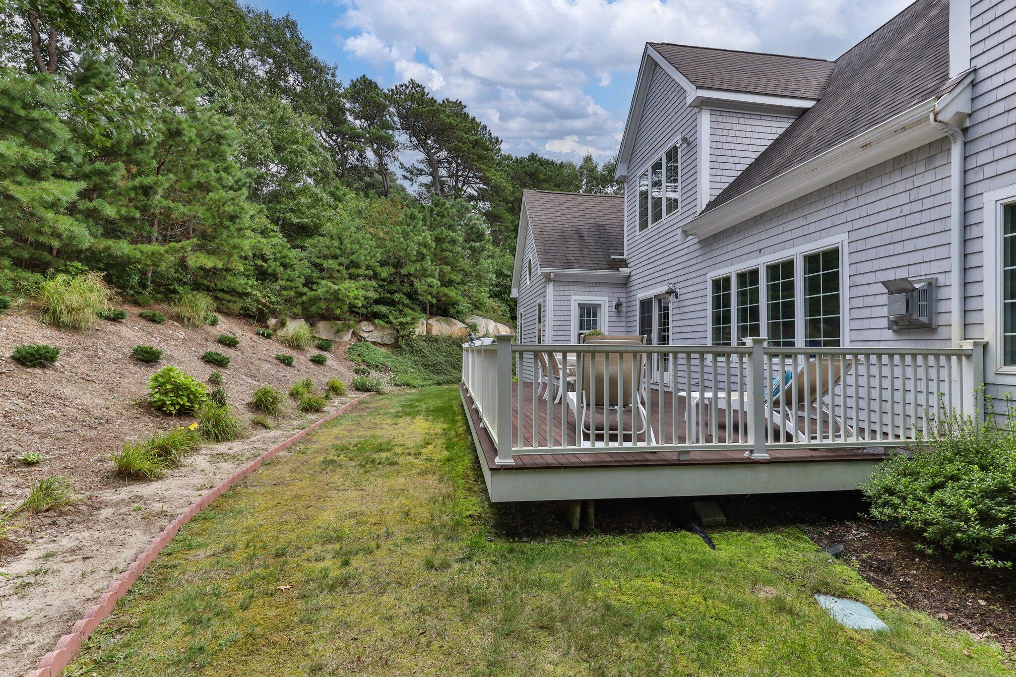 137 Cairn Ridge Road East Falmouth, MA 02536 - Photo 49 of 70 a view of a house with wooden deck and a yard
