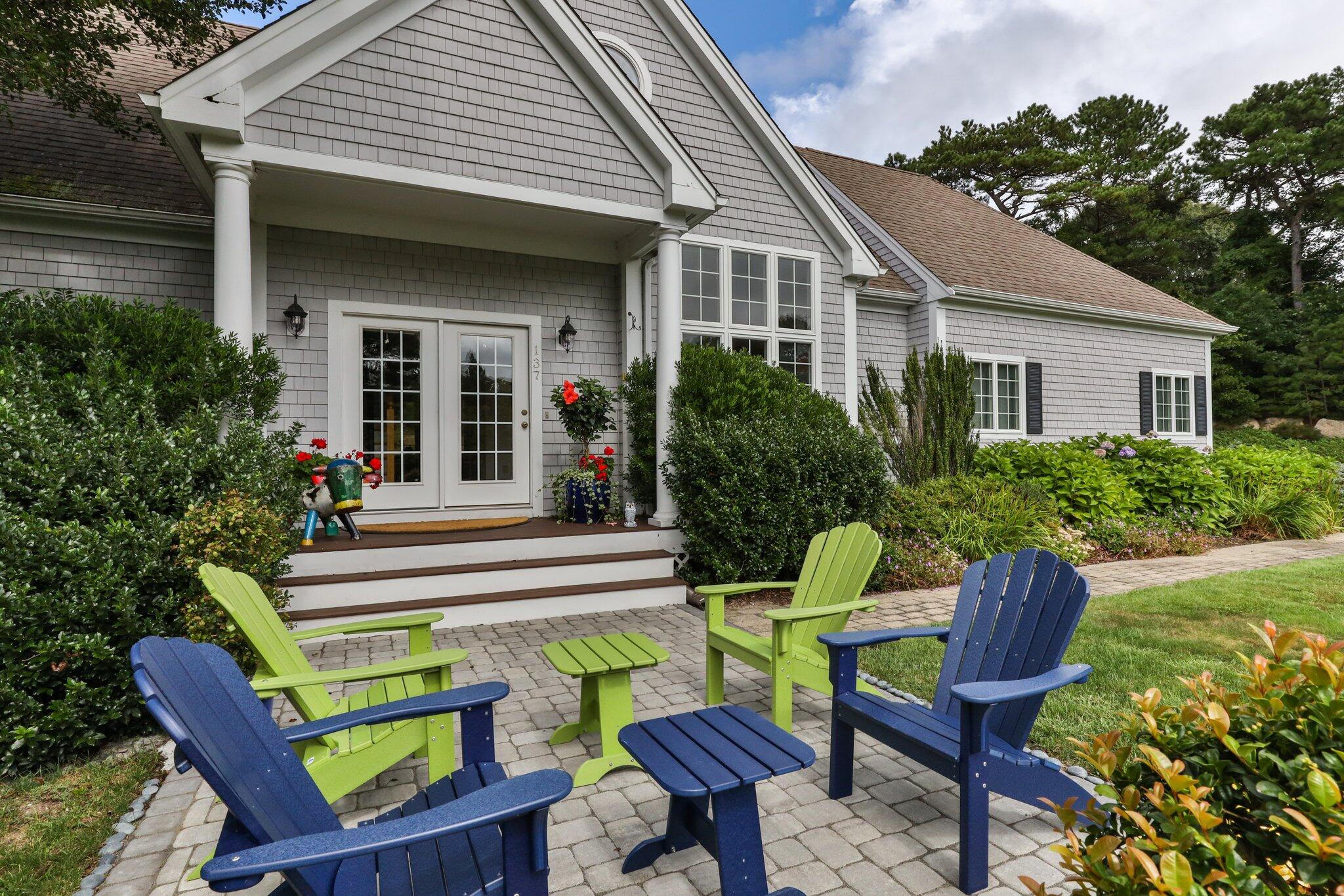 137 Cairn Ridge Road East Falmouth, MA 02536 - Photo 52 of 70 a view of a chair and table in back yard of the house