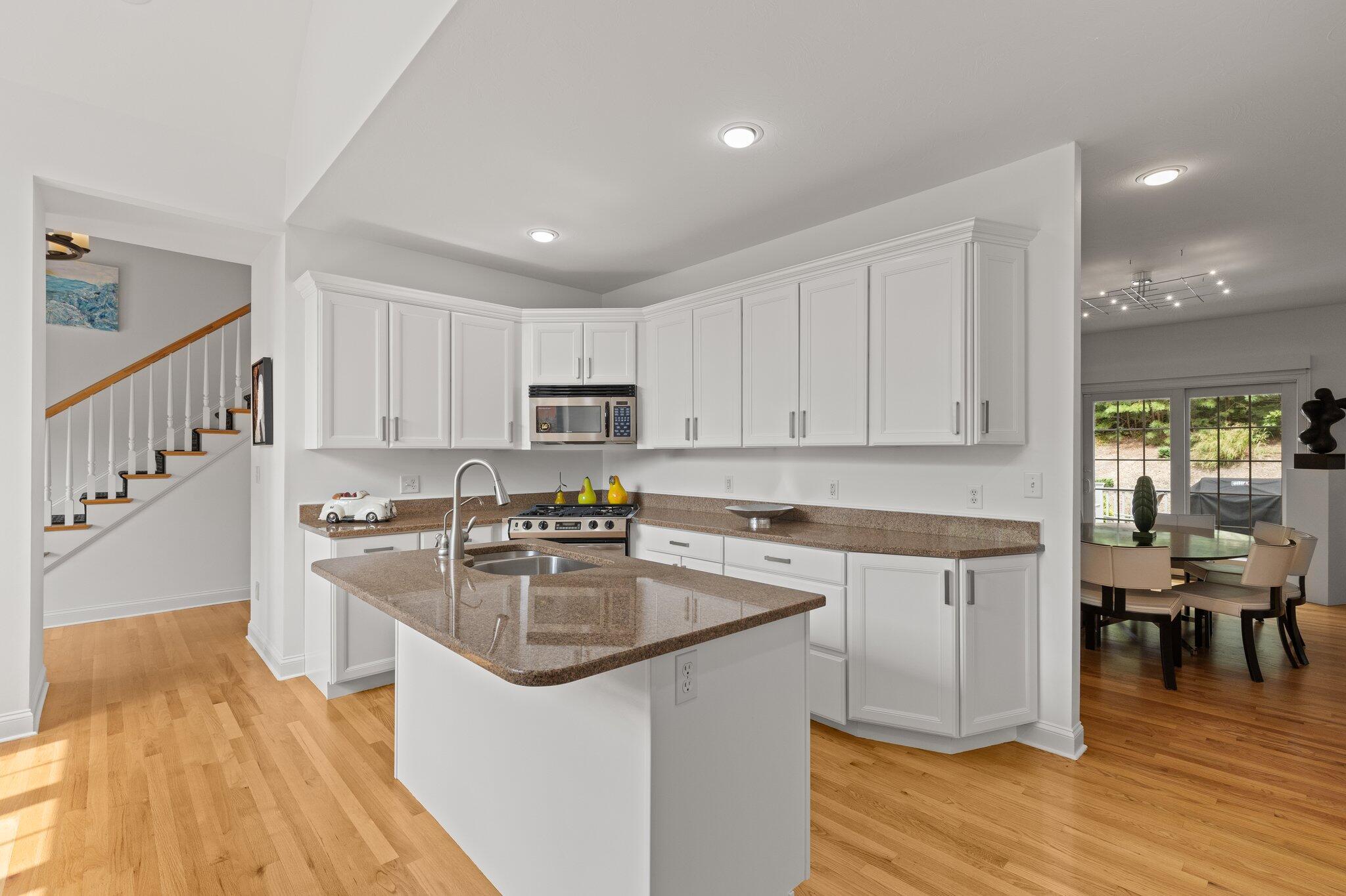137 Cairn Ridge Road East Falmouth, MA 02536 - Photo 7 of 70 a kitchen with granite countertop a sink a counter top space stainless steel appliances and cabinets