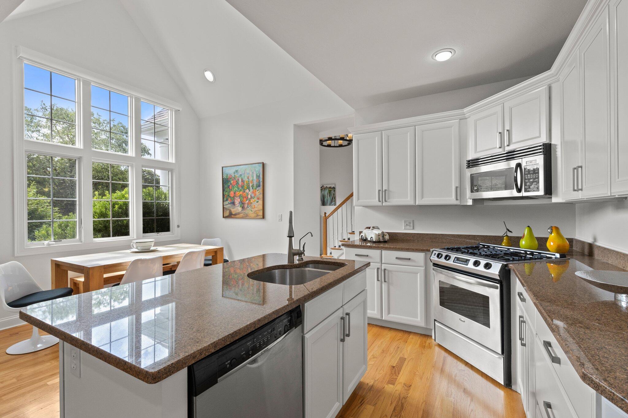 137 Cairn Ridge Road East Falmouth, MA 02536 - Photo 8 of 70 a kitchen with stainless steel appliances granite countertop a stove a sink and a microwave
