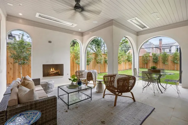 a living room with furniture and floor to ceiling windows