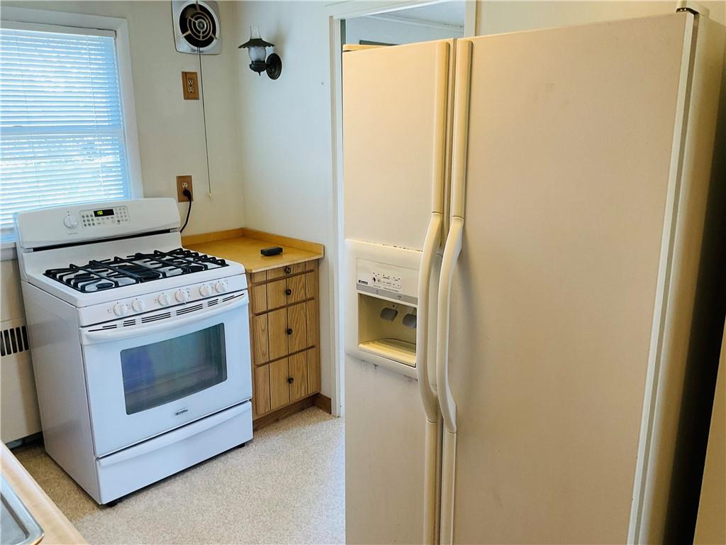 135 Constitution Circle Clairton, PA 15025 - Photo 13 of 40 a kitchen with a stove and a white cabinet