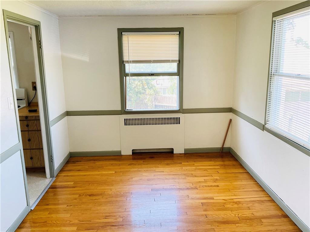 135 Constitution Circle Clairton, PA 15025 - Photo 15 of 40 a view of an empty room with wooden floor and a window