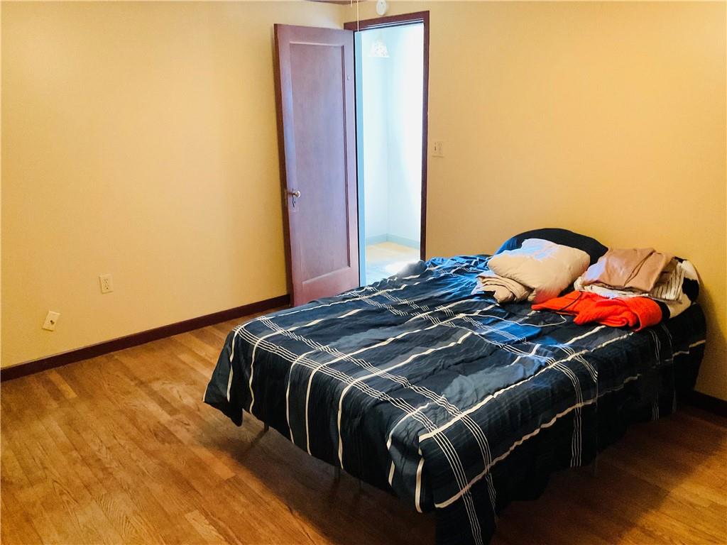 135 Constitution Circle Clairton, PA 15025 - Photo 20 of 40 a bedroom with a bed and wooden floor