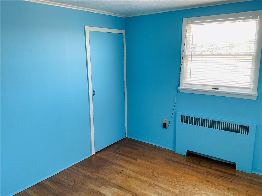 135 Constitution Circle Clairton, PA 15025 - Photo 25 of 40 a view of an empty room with wooden floor and a window