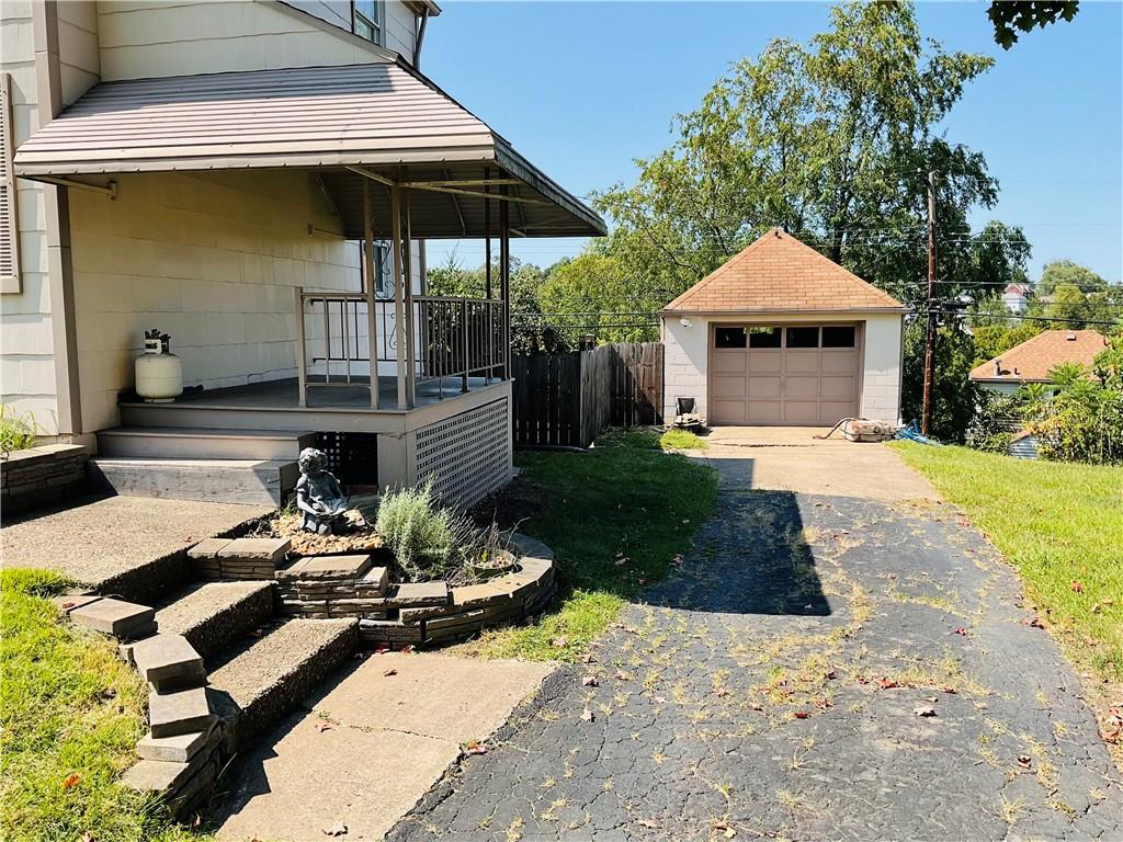 135 Constitution Circle Clairton, PA 15025 - Photo 38 of 40 a view of a patio with couches table and chairs under an umbrella