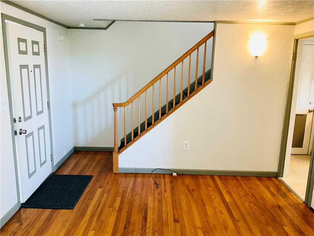 135 Constitution Circle Clairton, PA 15025 - Photo 5 of 40 a view of a hallway with wooden floor and staircase