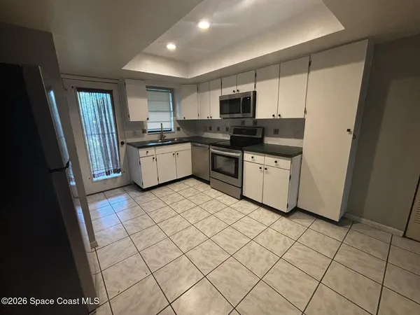 a kitchen with stainless steel appliances granite countertop a refrigerator sink and cabinets