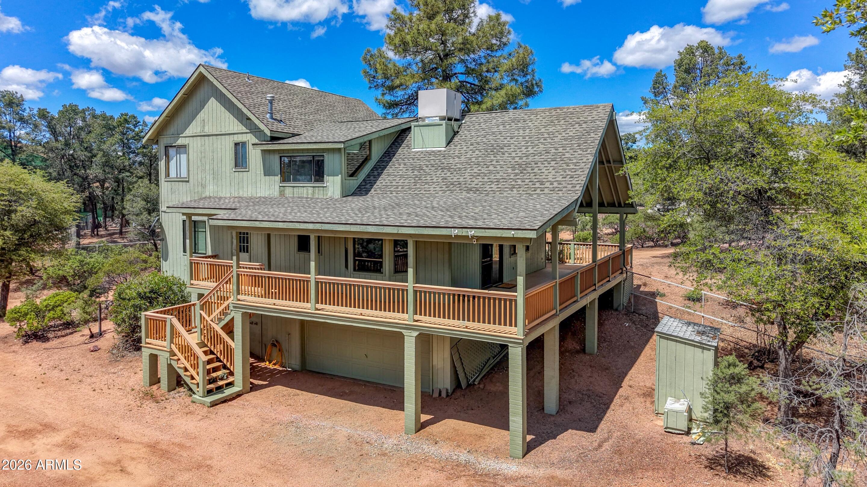 1405 East Graham Rnch Trail Payson, AZ 85541 - Photo 28 of 46 a front view of a house with a yard and wooden fence