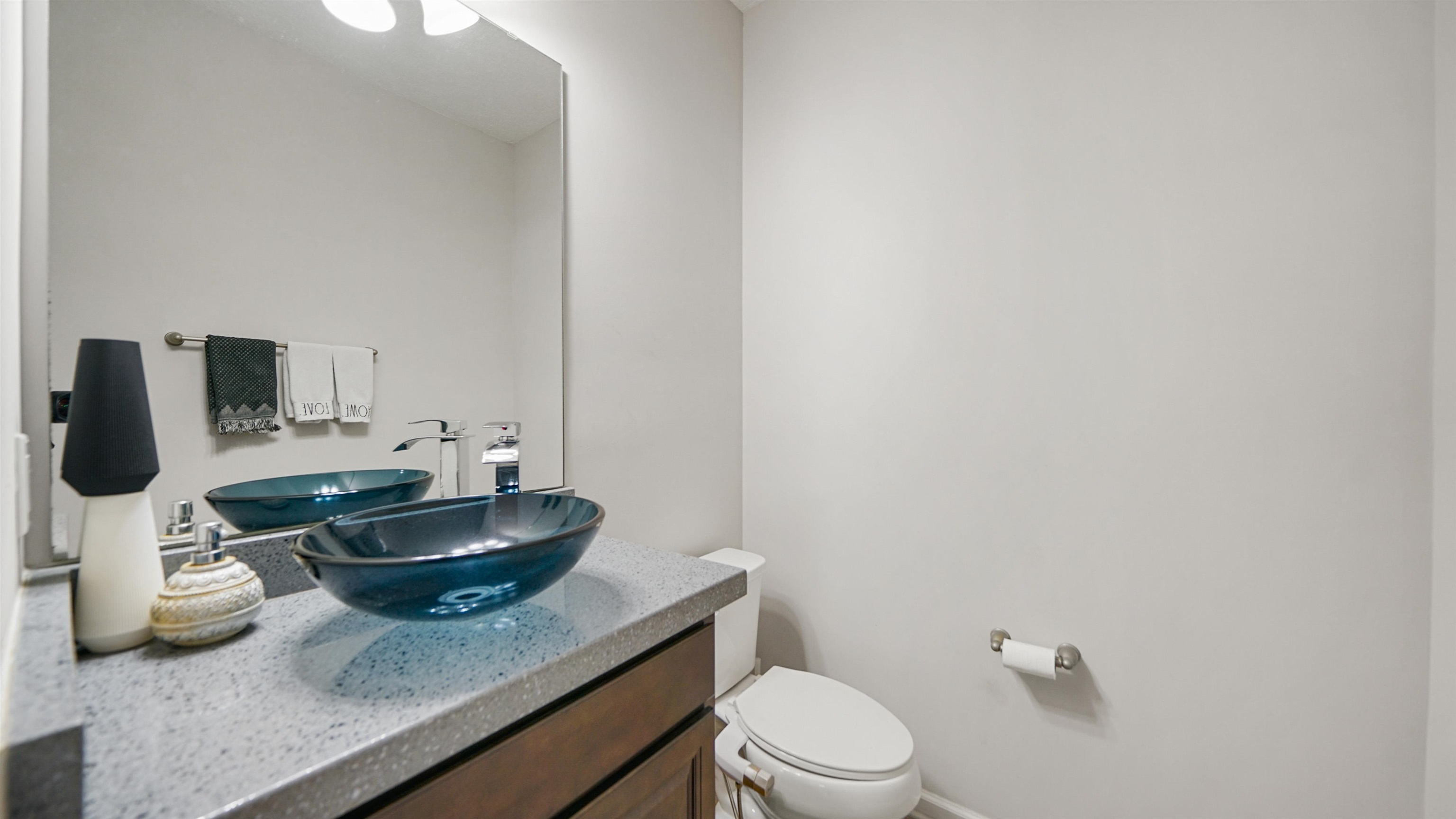 514 Heron Landing Road St. Johns, FL 32259 - Photo 14 of 48 a bathroom with a granite countertop sink a toilet and a mirror