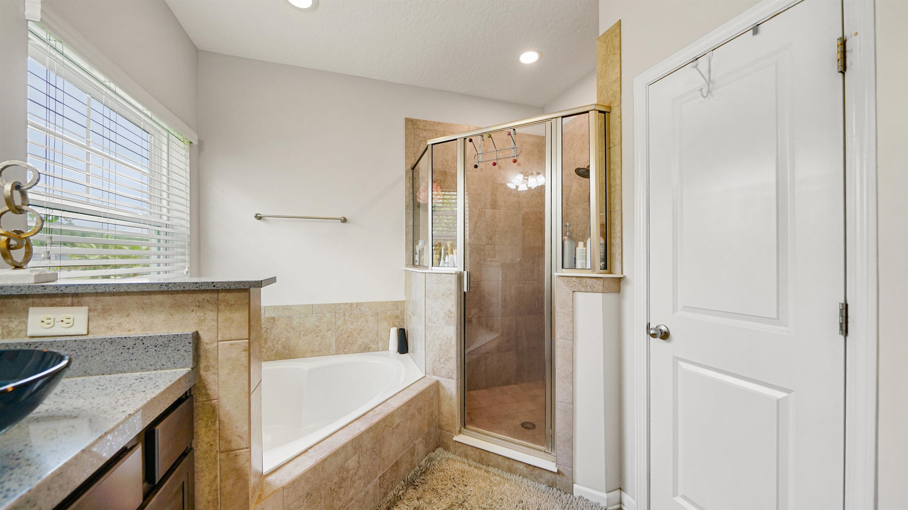 514 Heron Landing Road St. Johns, FL 32259 - Photo 24 of 48 a bathroom with a tub a sink and a shower