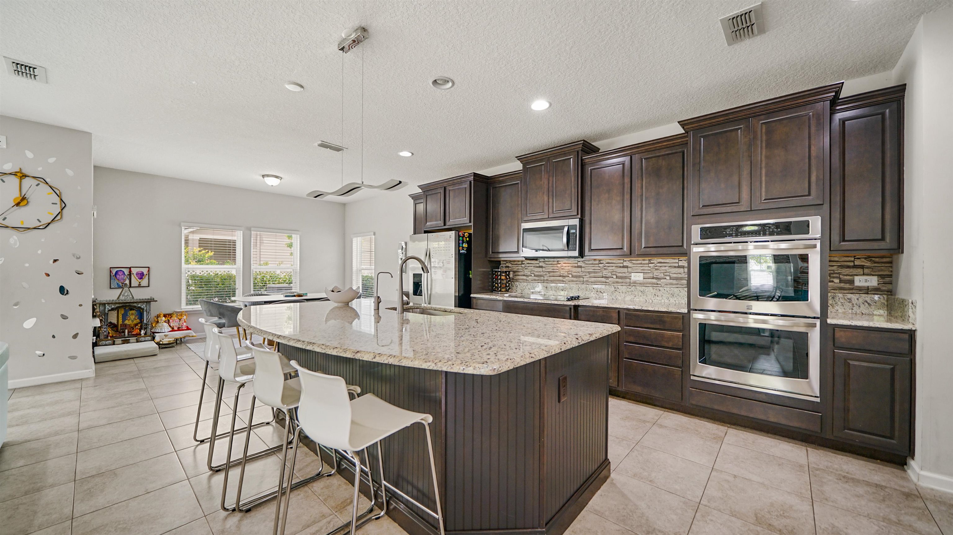 514 Heron Landing Road St. Johns, FL 32259 - Photo 3 of 48 a kitchen with stainless steel appliances kitchen island granite countertop a sink and cabinets