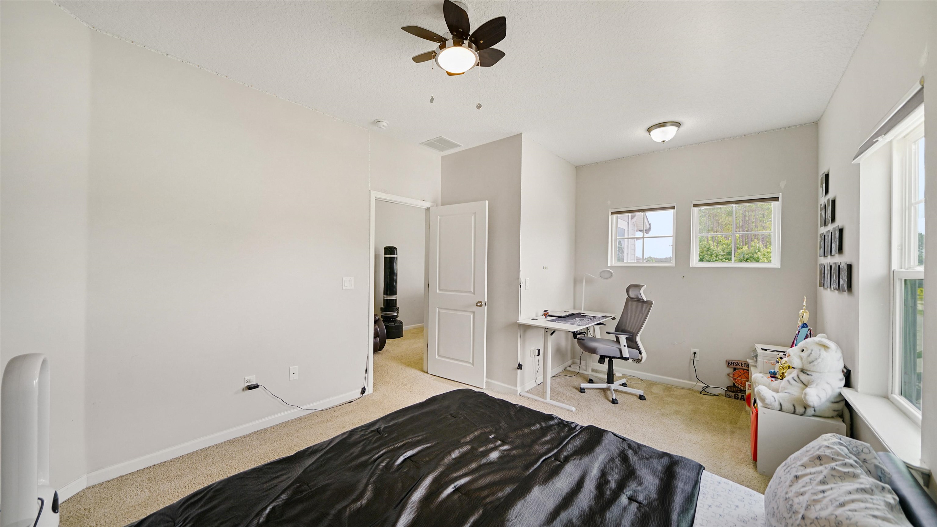 514 Heron Landing Road St. Johns, FL 32259 - Photo 31 of 48 a bedroom with a bed and a chandelier fan