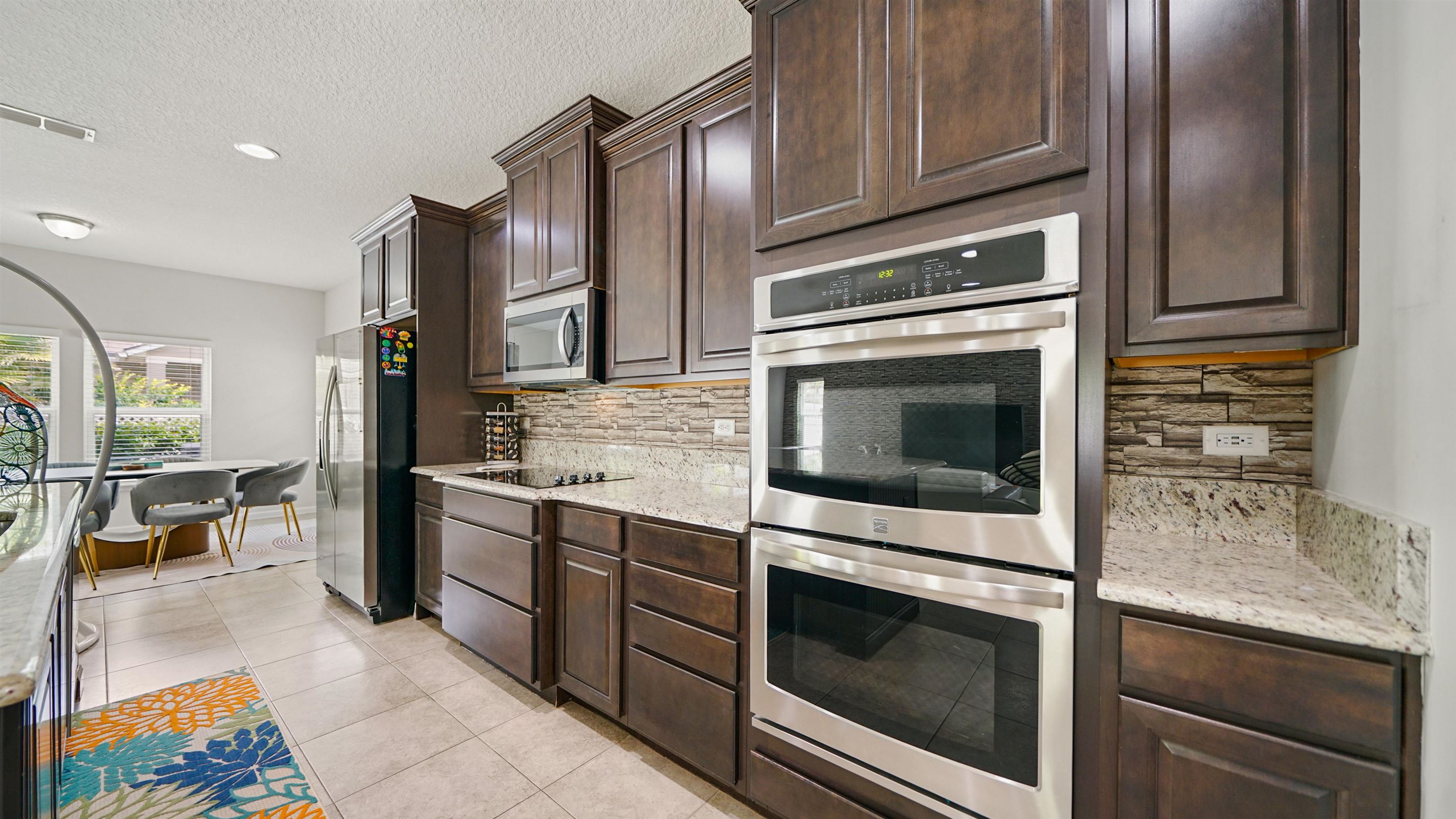 514 Heron Landing Road St. Johns, FL 32259 - Photo 7 of 48 a kitchen with granite countertop cabinets stainless steel appliances and counter space