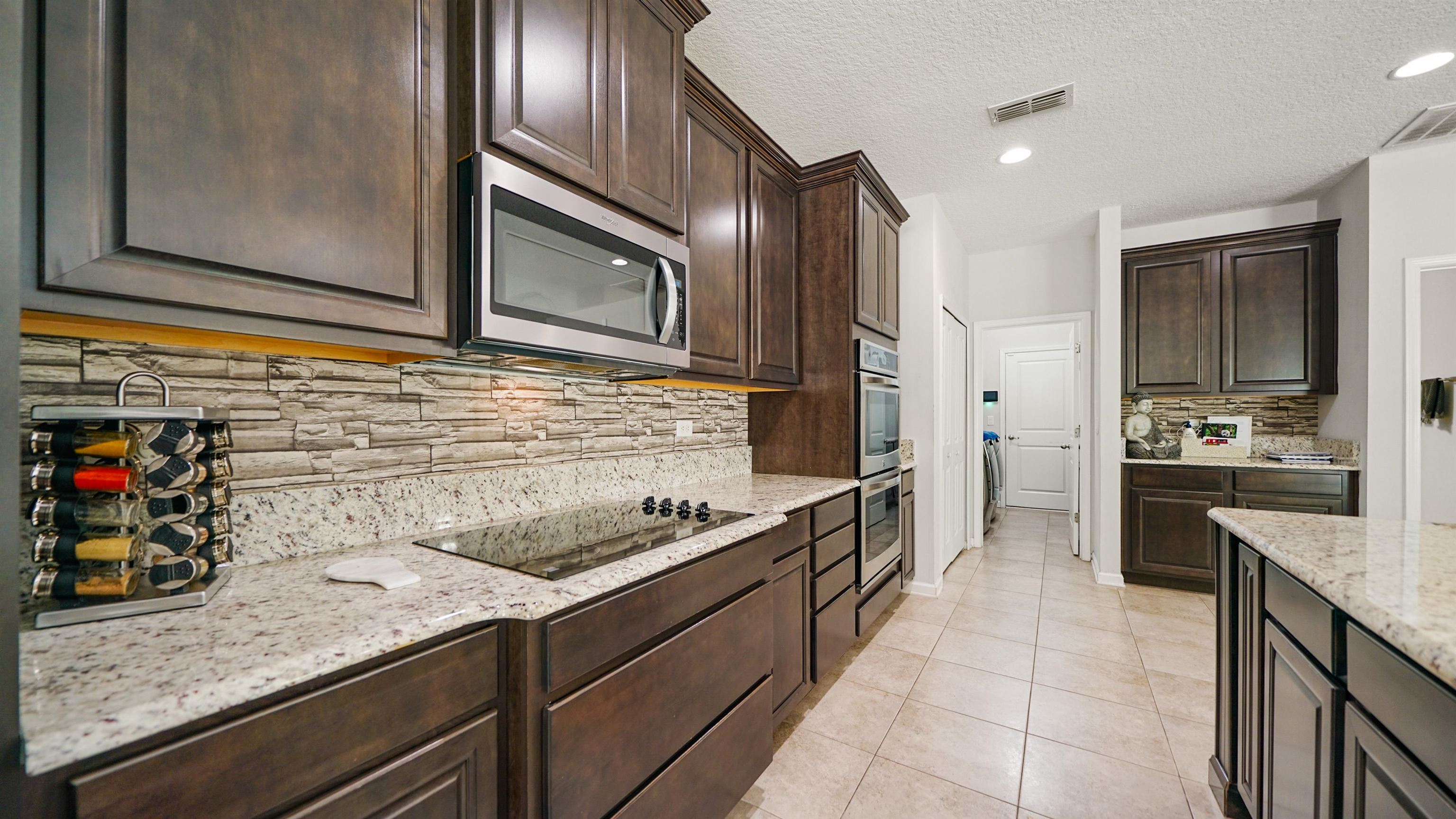 514 Heron Landing Road St. Johns, FL 32259 - Photo 9 of 48 a kitchen with stainless steel appliances granite countertop a sink stove and refrigerator