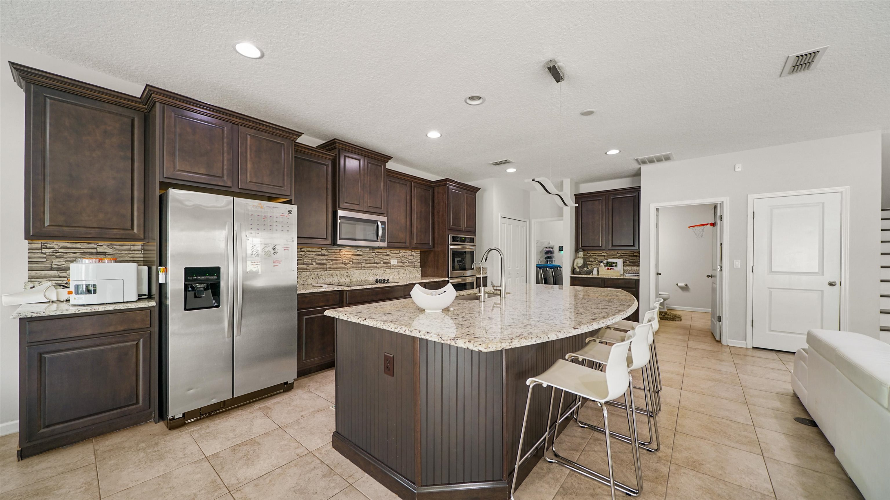 514 Heron Landing Road St. Johns, FL 32259 - Photo 10 of 48 a kitchen with stainless steel appliances granite countertop a sink refrigerator and cabinets