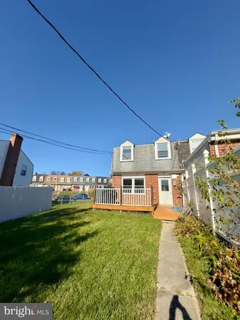 a front view of a house with a yard table and chairs