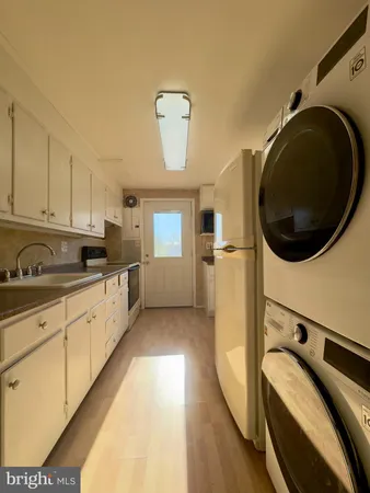 a kitchen with stainless steel appliances granite countertop a sink a stove and cabinets