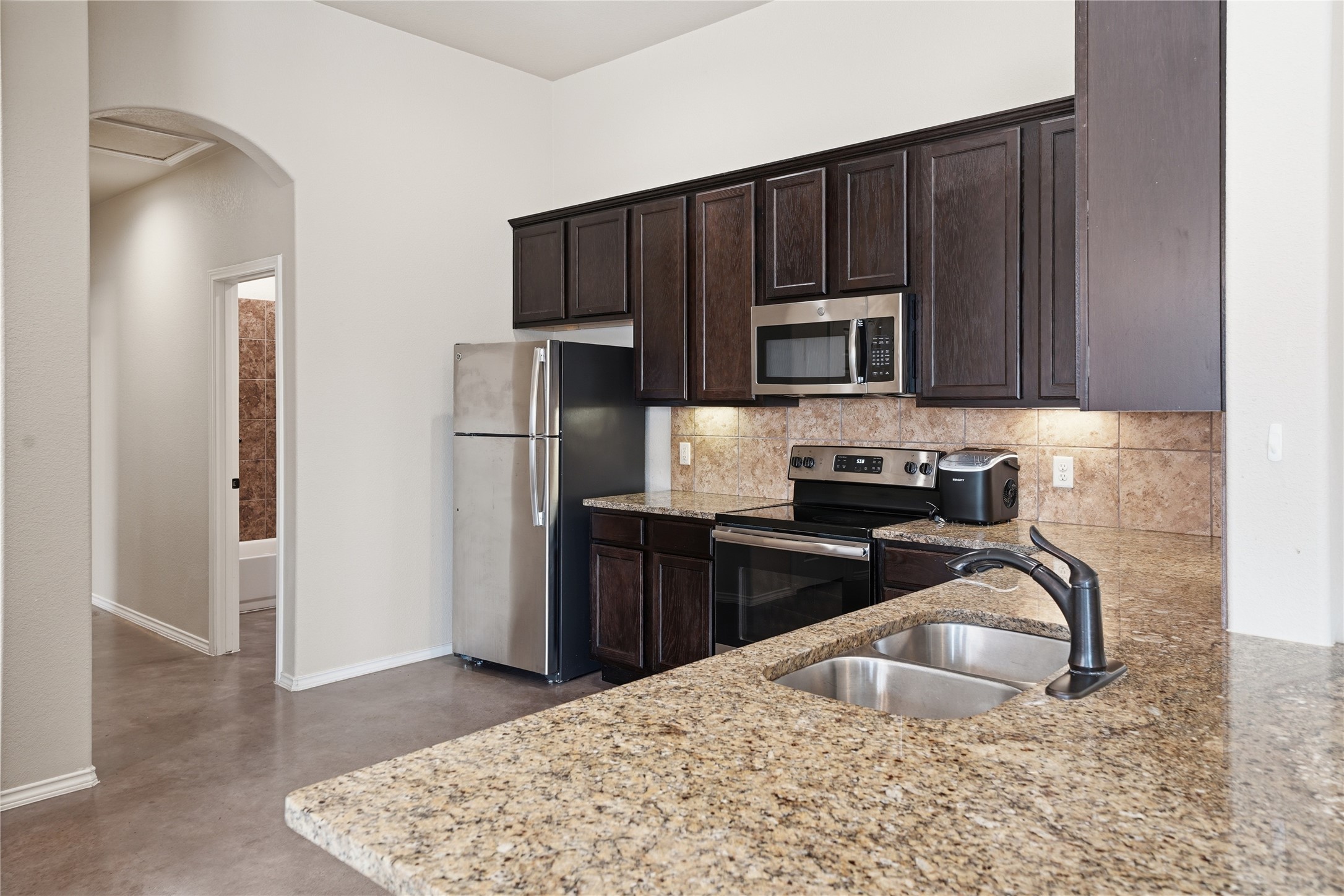 533 Jack Rabbit Lane, Unit A Buda, TX 78610 - Photo 15 of 34 Granite counters and stainless steel appliances complete this compact, functional kitchen.