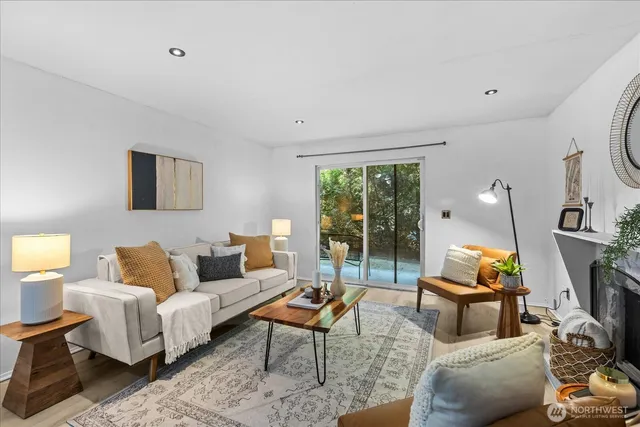 a living room with furniture and a floor to ceiling window