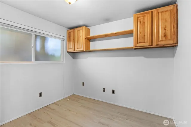 a view of an entryway with wooden floor