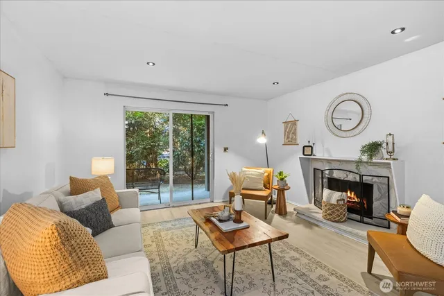 a living room with furniture a clock and a large window