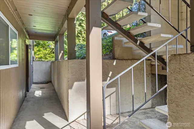 a view of a backyard with furniture and a tree